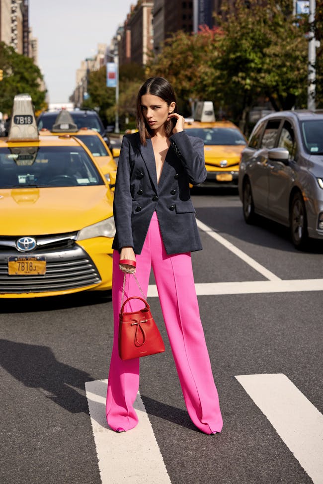 A woman wearing pink pants and a blazer