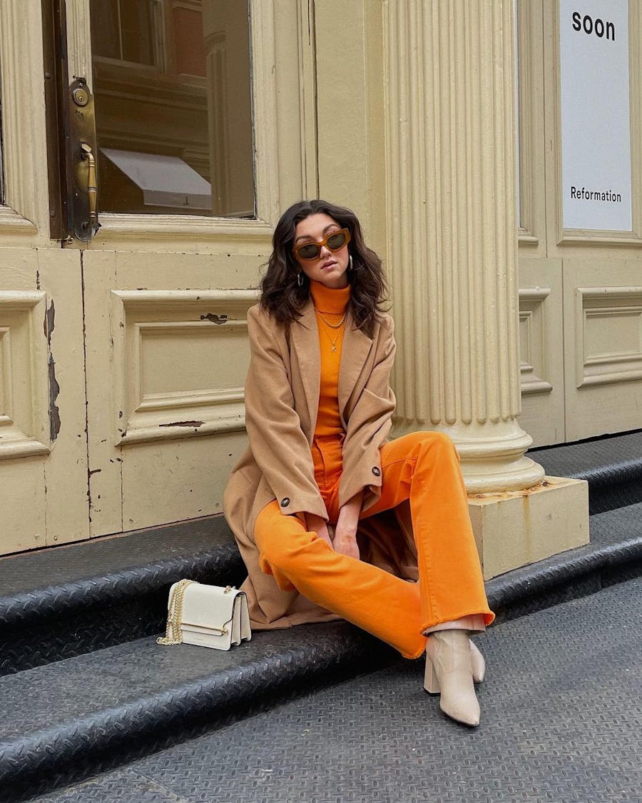 A woman sitting on the steps of a building