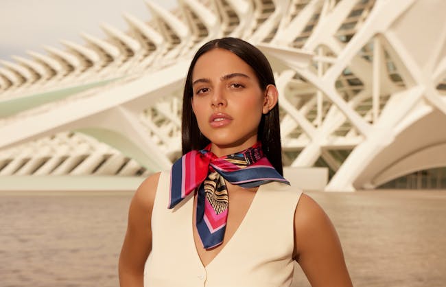 A woman standing in front of a large building