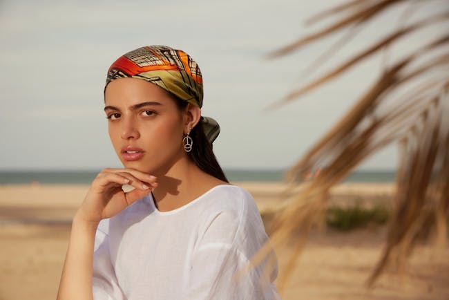 A woman in a white shirt and a colorful head scarf