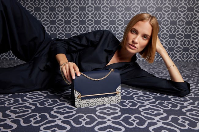 A woman laying on the floor with a purse