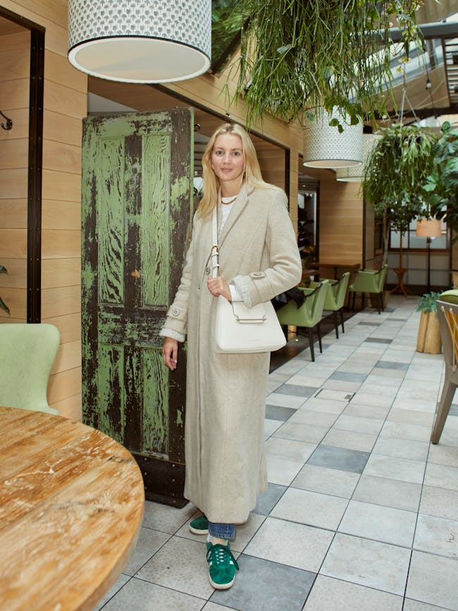 A woman standing in front of a wooden table