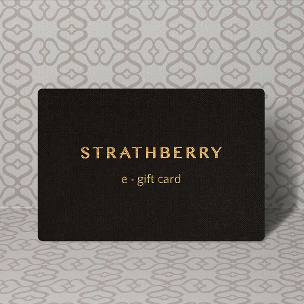 A black and gold gift card sitting on top of a table