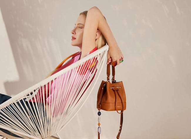 A woman sitting in a chair with a handbag