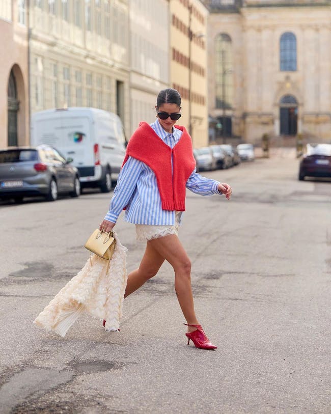A woman is walking down the street carrying shopping bags