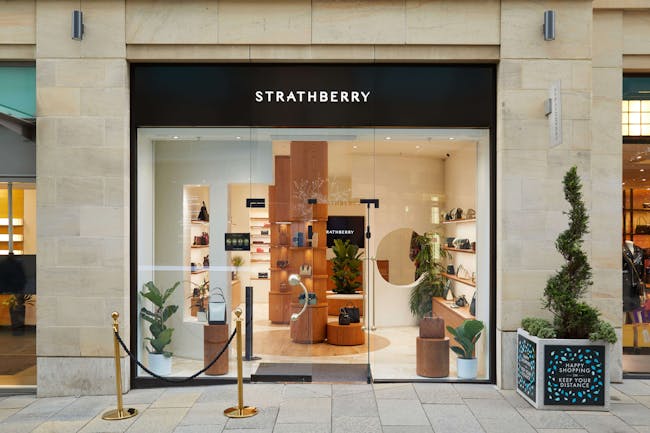 A store front with a display of potted plants