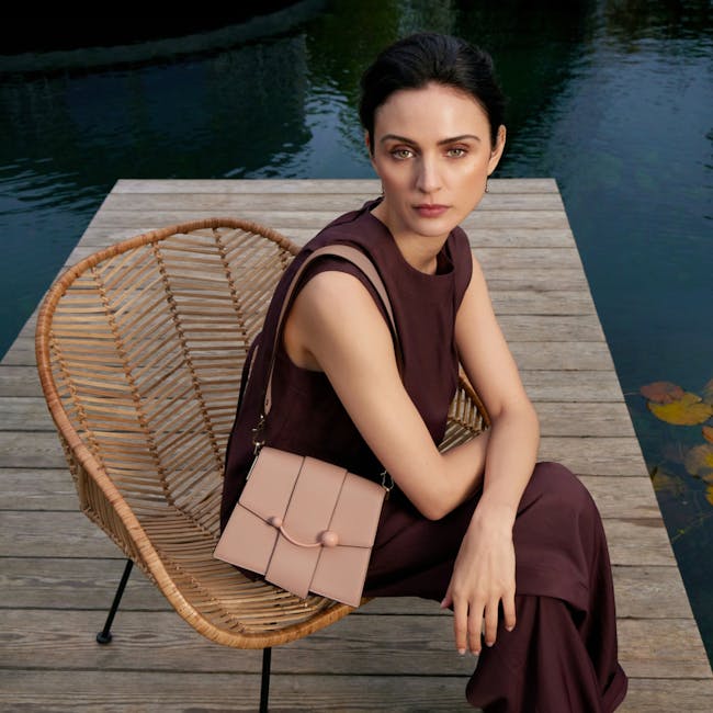 A woman sitting on a chair on a dock