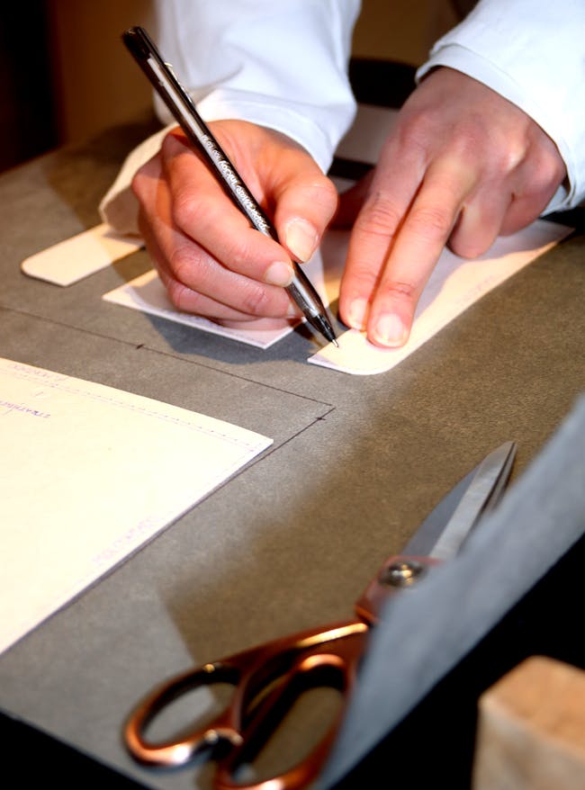 A detailed shot from our event in Edinburgh, in partnership with Hamilton and Inches. One of our atelier workers, marking the pattern of the handbag on one of our leather samples.
