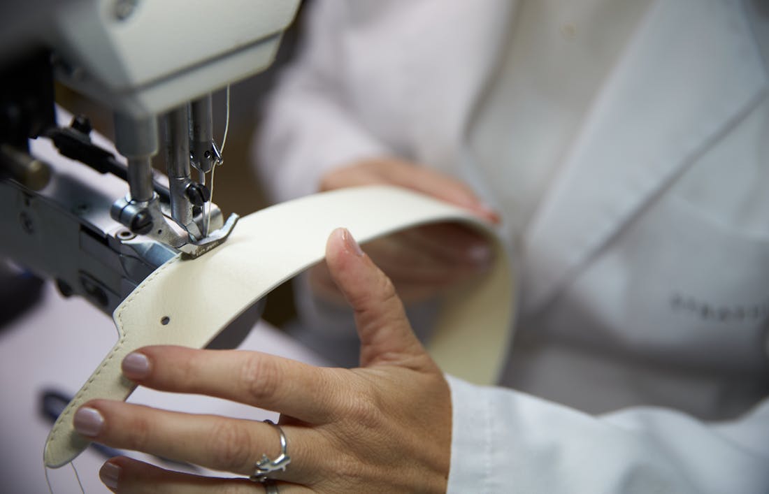 A detailed shot of the construction of a Strathberry handbag. Focusing on the stitching around the leather adjustable straps included with the handbags, shown in the atelier in Ubrique, Spain.