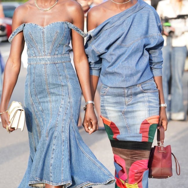 A couple of women walking down a street