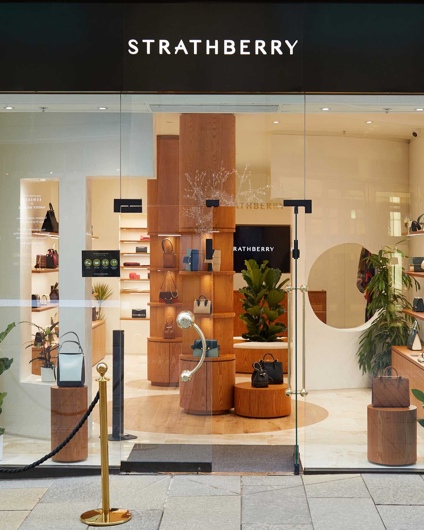 A store front with a display of wooden furniture