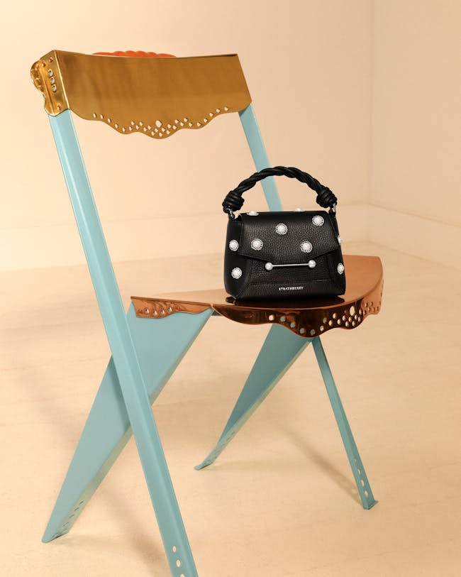 A chair with a purse sitting on top of it