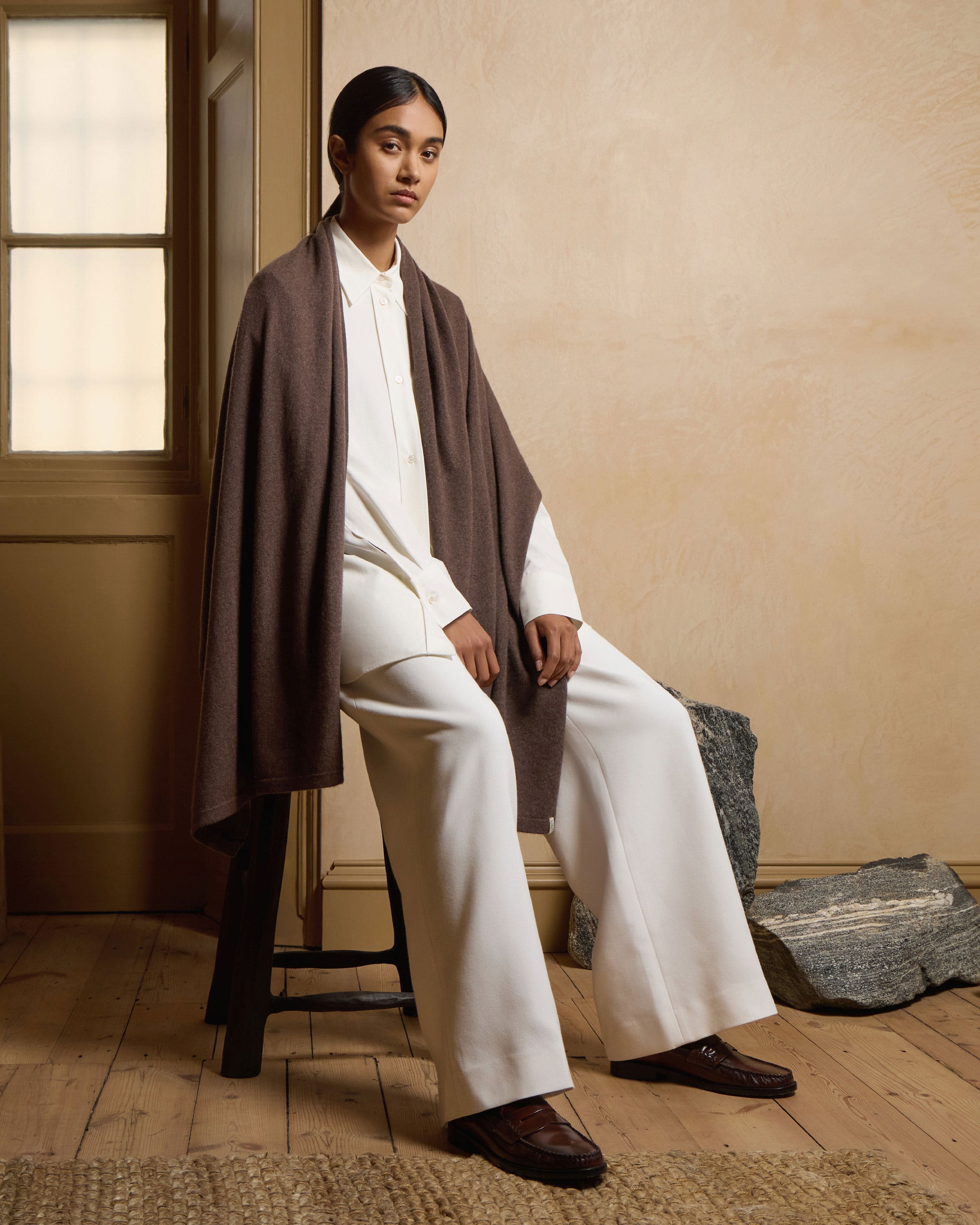 A woman sitting on a chair in a room