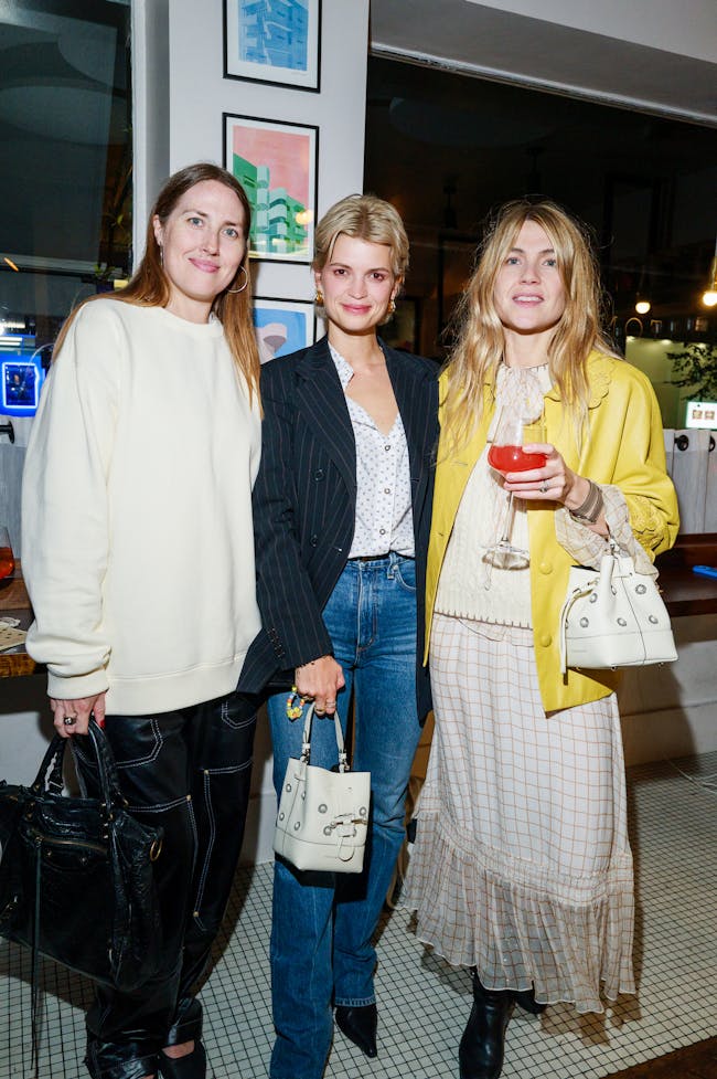 A group of three women standing next to each other