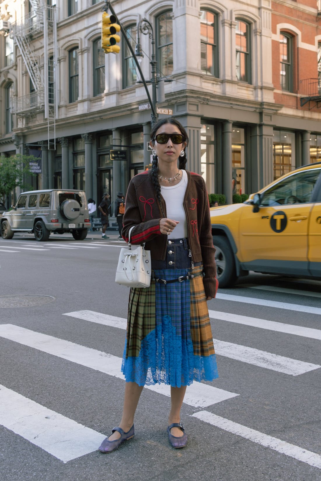 A woman standing on the side of a street