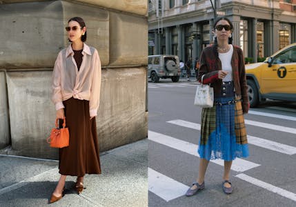 Two women standing on the side of a street