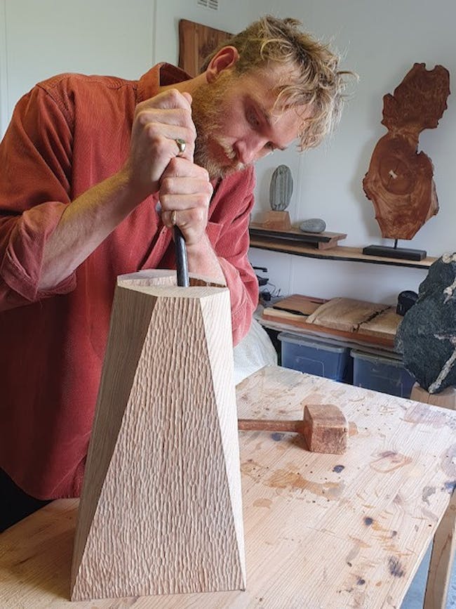 A man working on a piece of wood