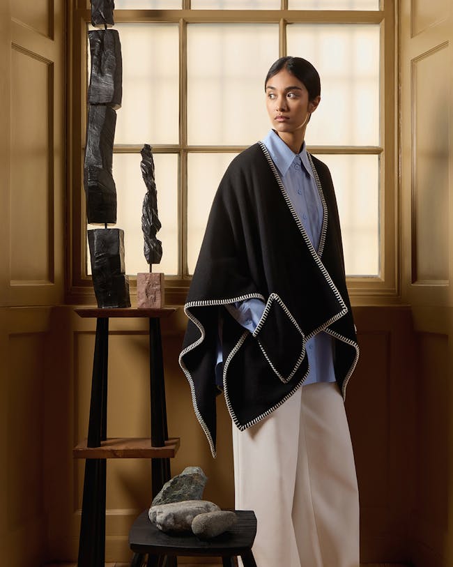 A woman standing in front of a window in a room