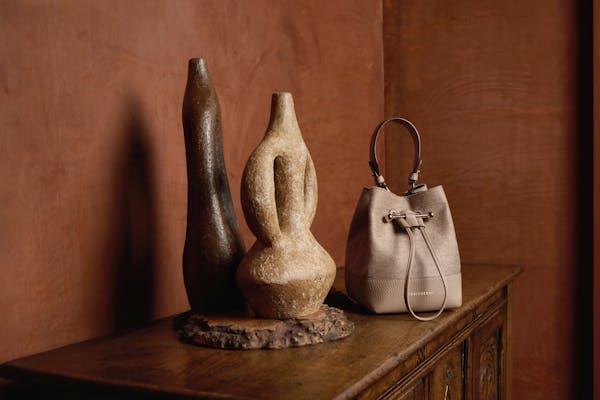 A white purse sitting on top of a wooden table