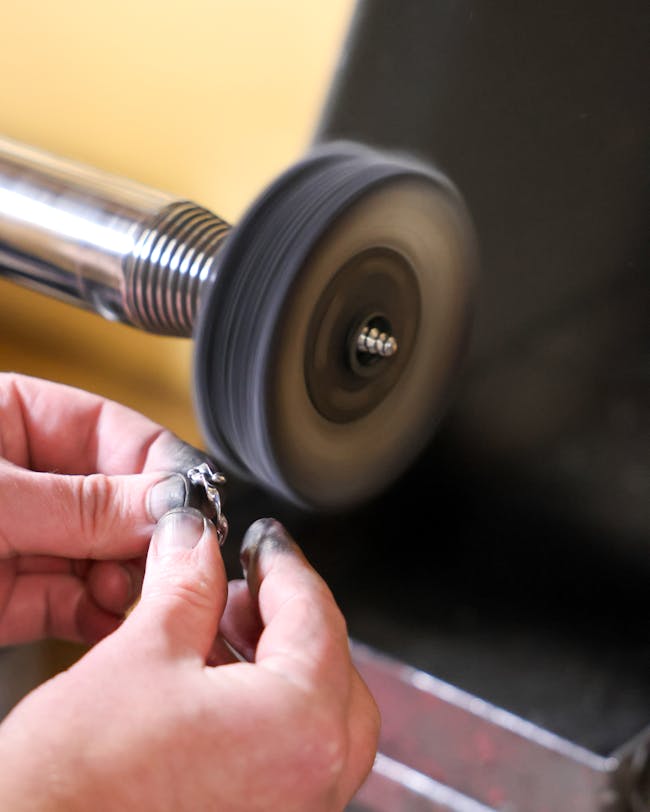 A person is working on a metal object