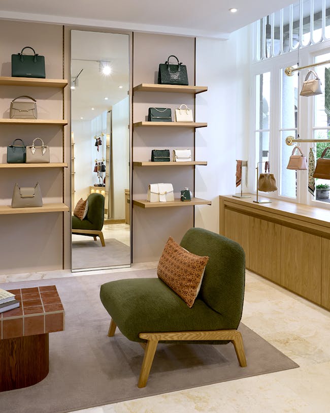 A green chair sitting in front of a mirror