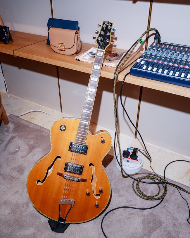 A guitar sitting on the floor in a room