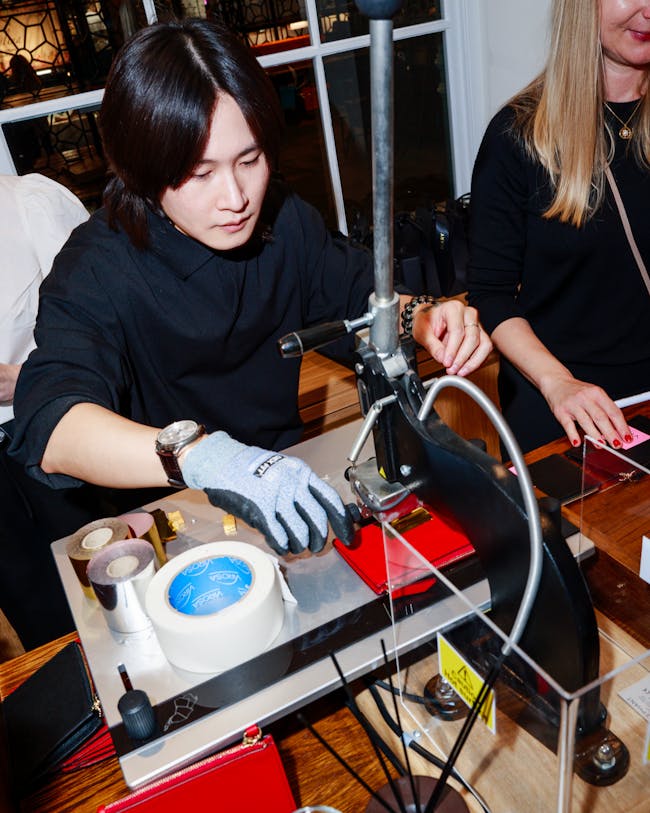 A woman in a black shirt is working on a project