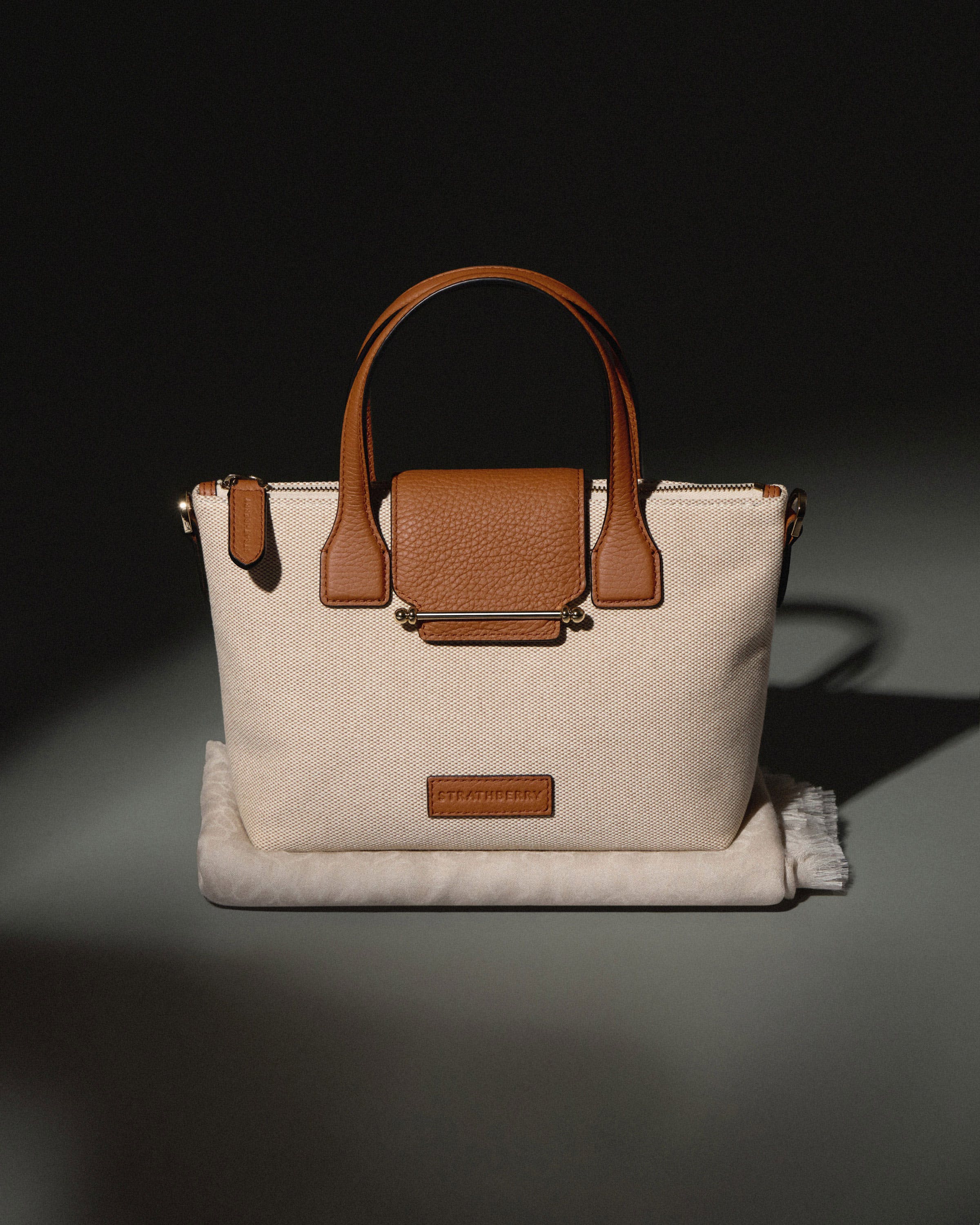 A white and brown purse sitting on top of a table