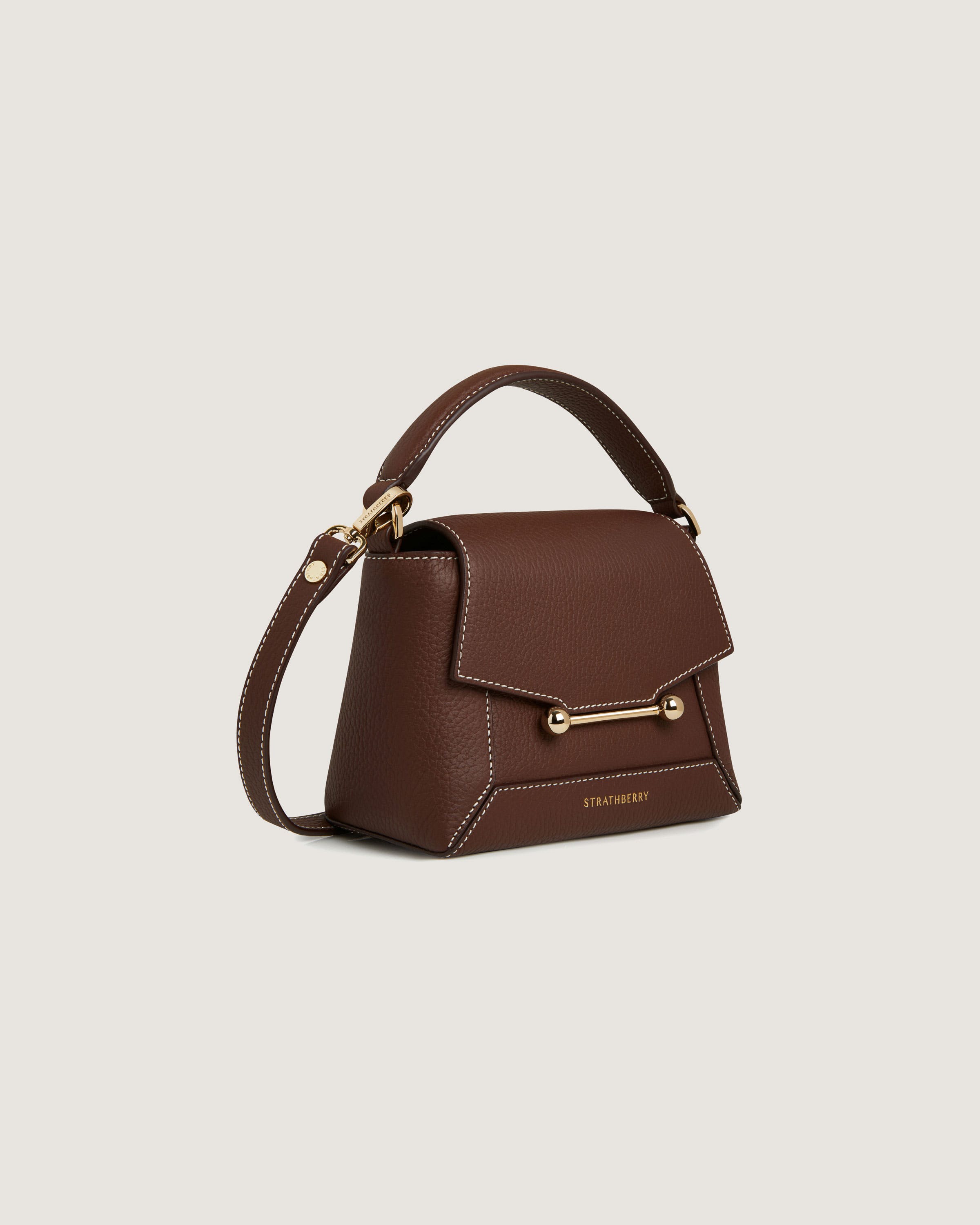 A brown handbag with a gold handle