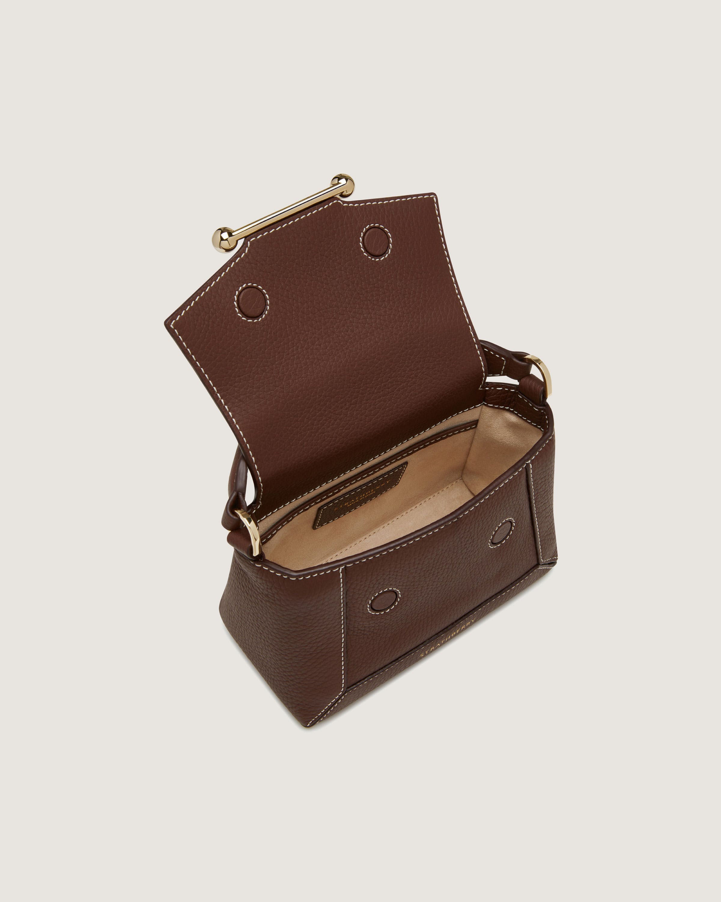 A brown leather purse with a zipper on the inside