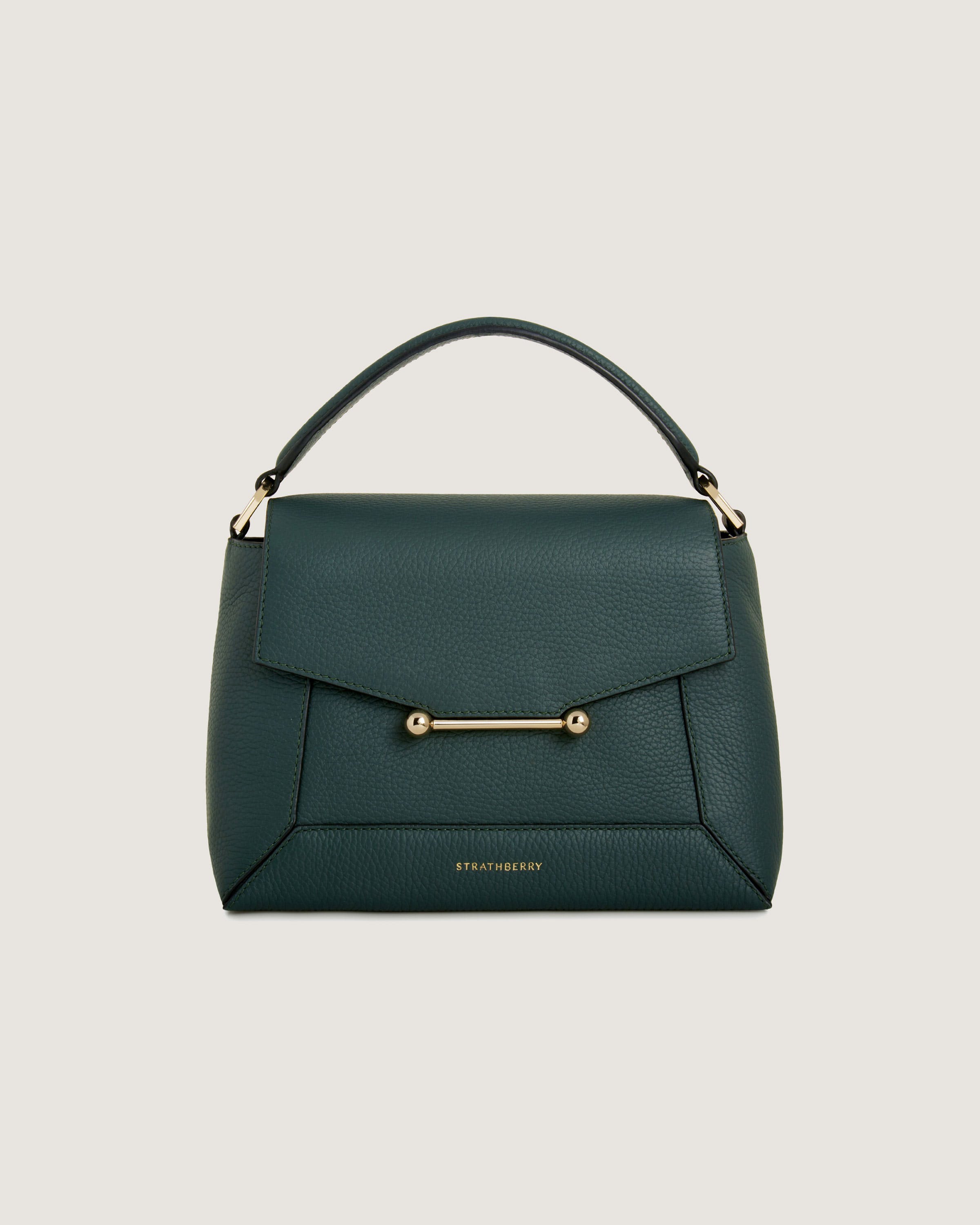 A green handbag with a gold handle