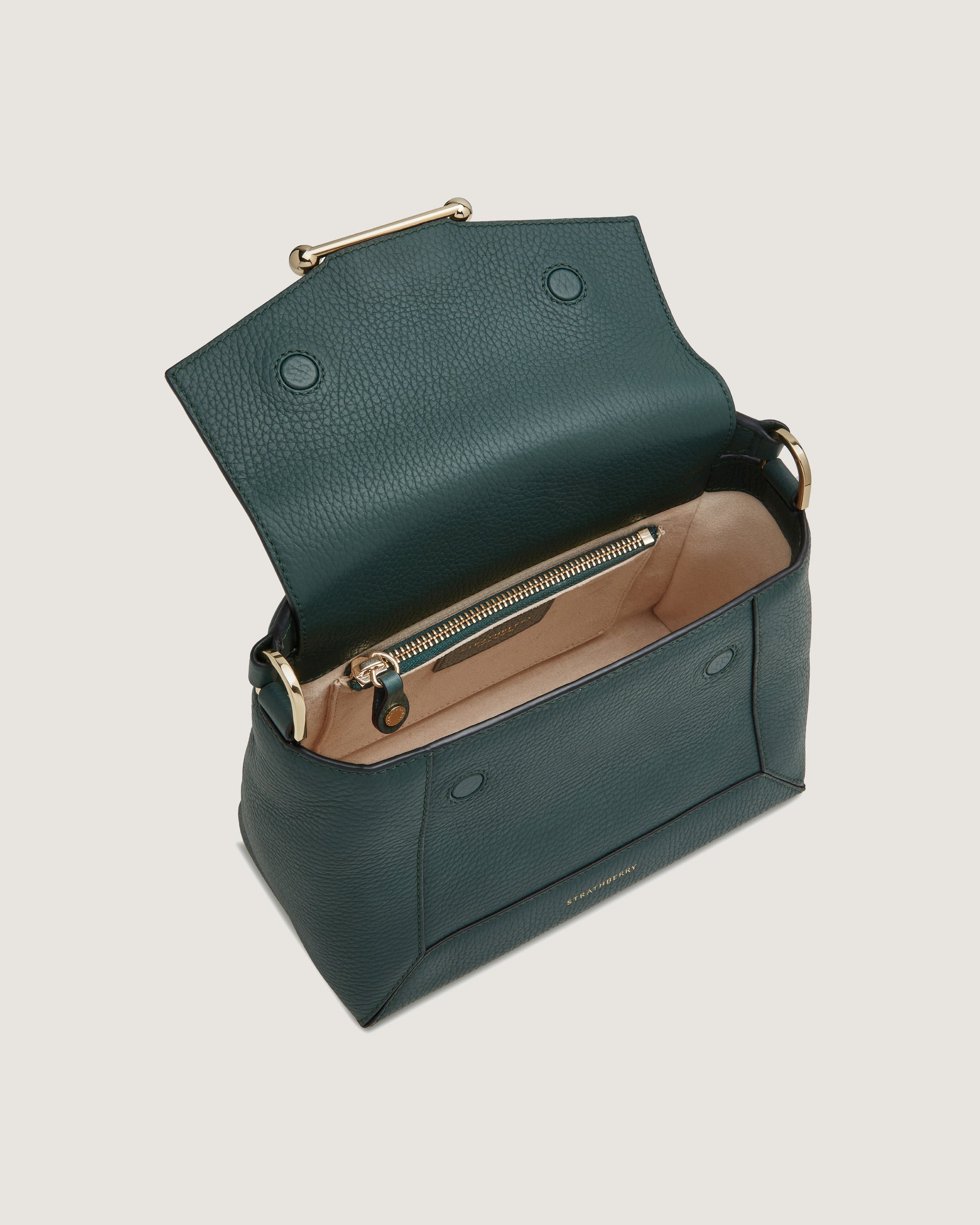 A green handbag with a gold handle