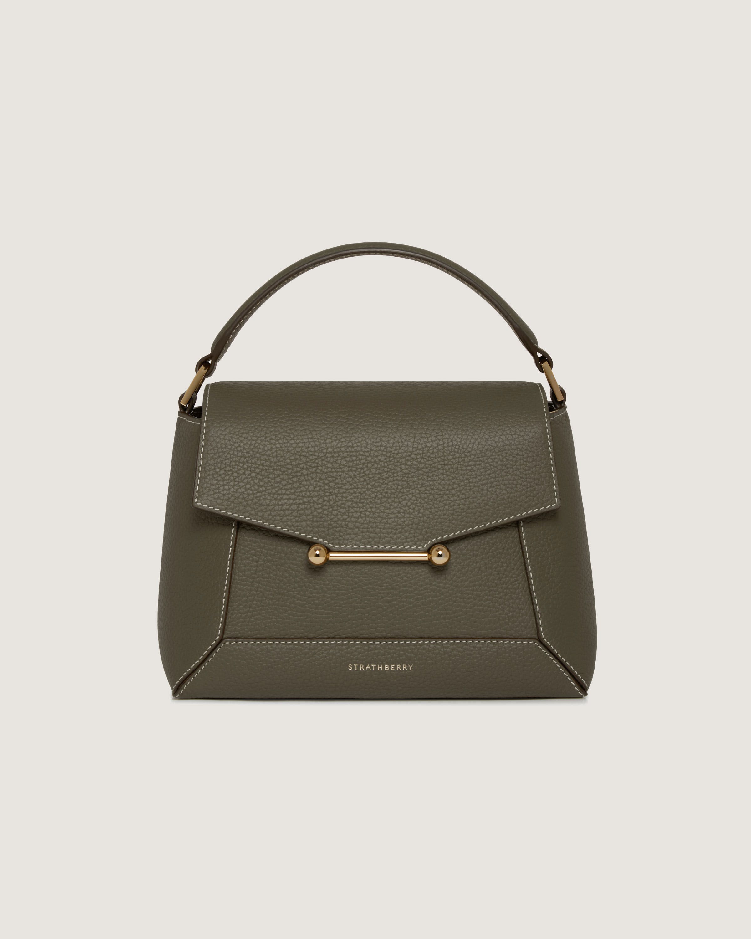 A green handbag with a gold handle