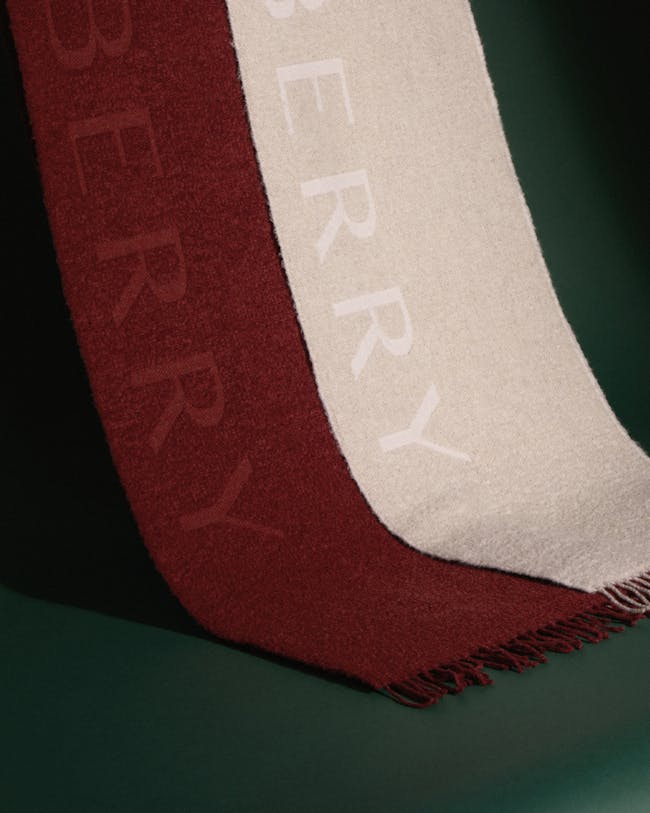 A red, white and black blanket with the words poetry on it