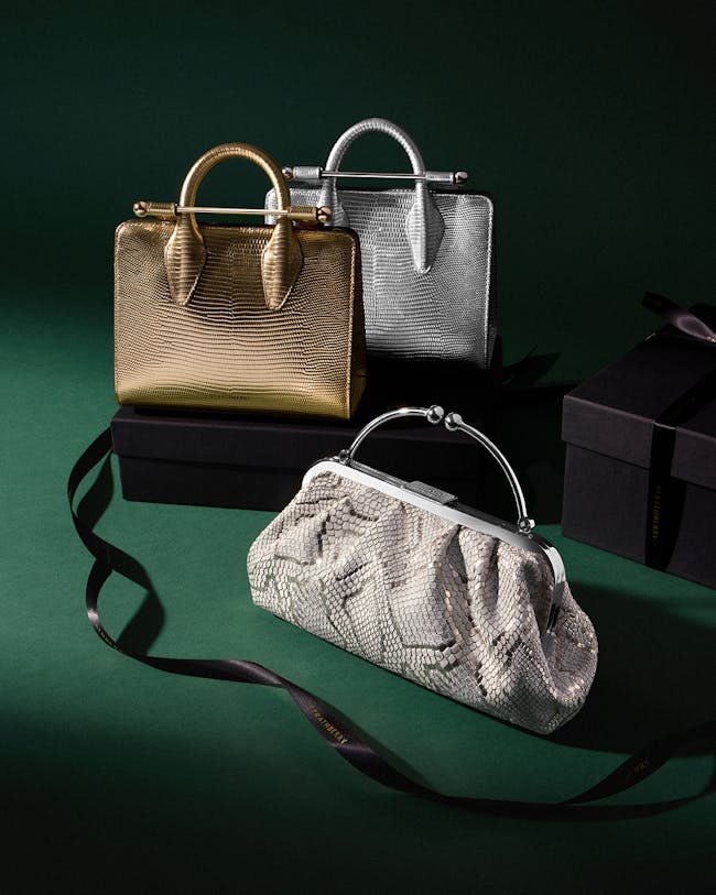 Three purses sitting on top of a green surface