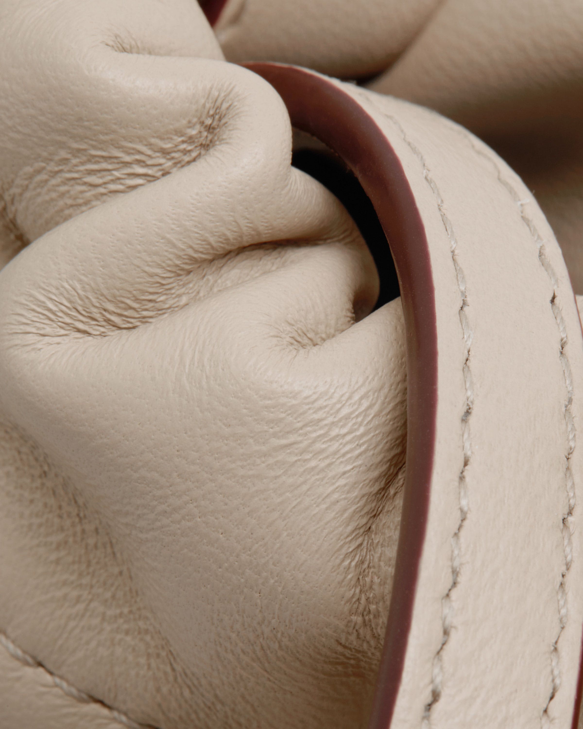 A close up of a white leather purse