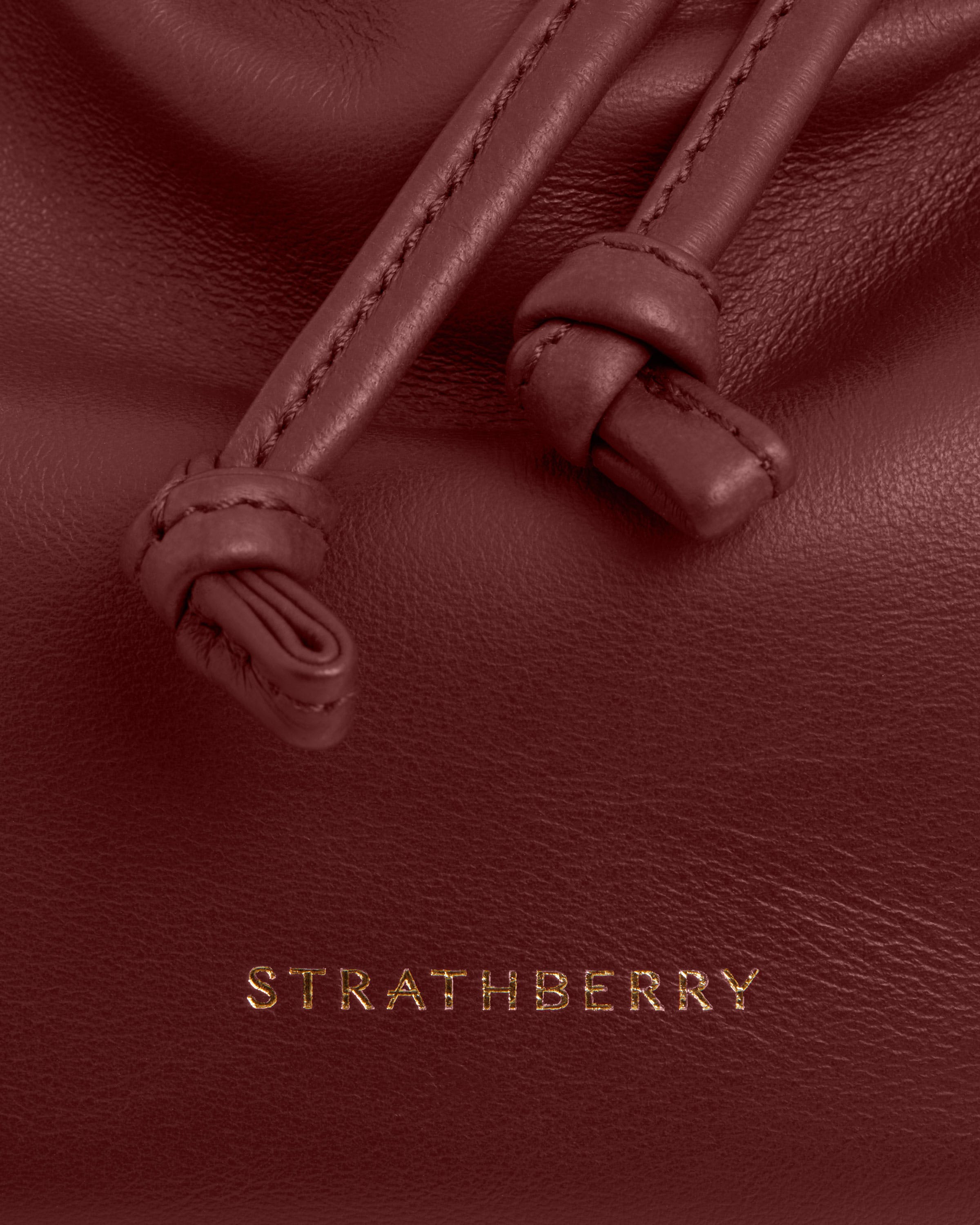 A close up of a red leather bag