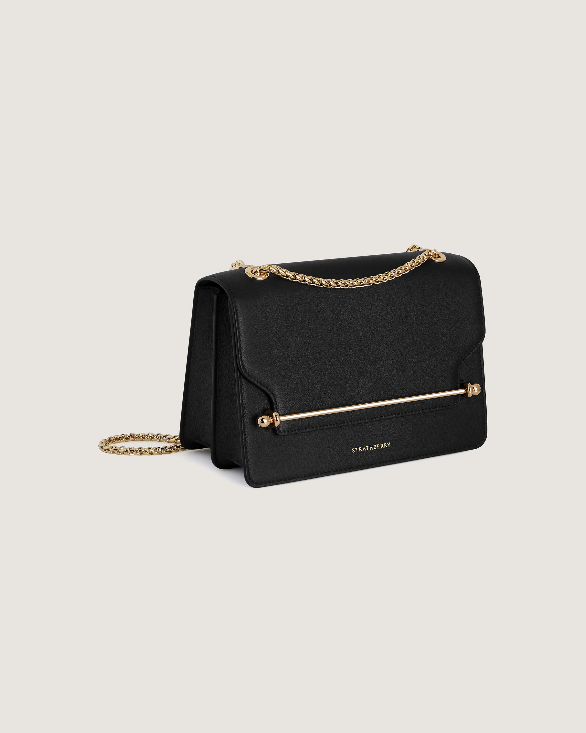 A black handbag with a gold chain strap