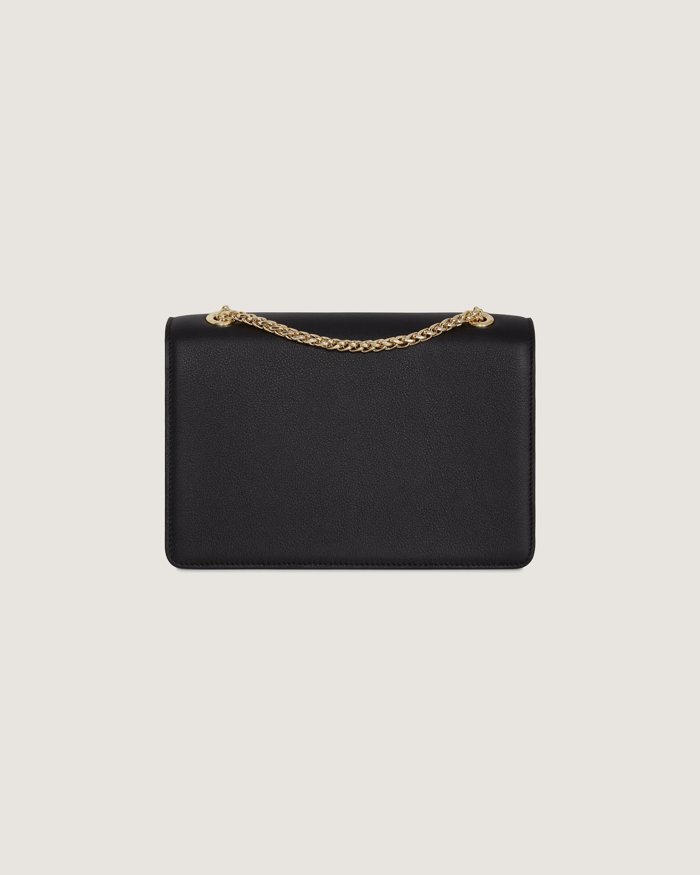 A black clutch bag with a gold chain