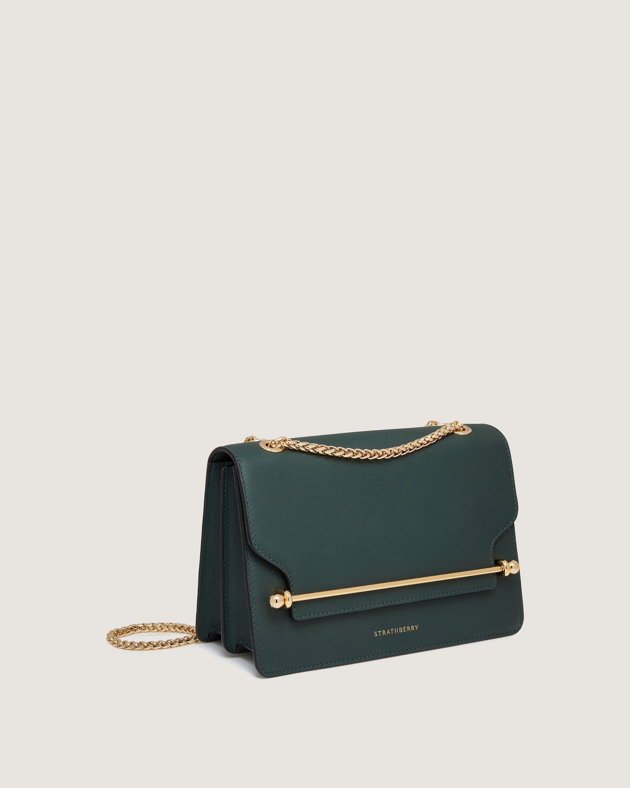 A green handbag with a gold chain strap