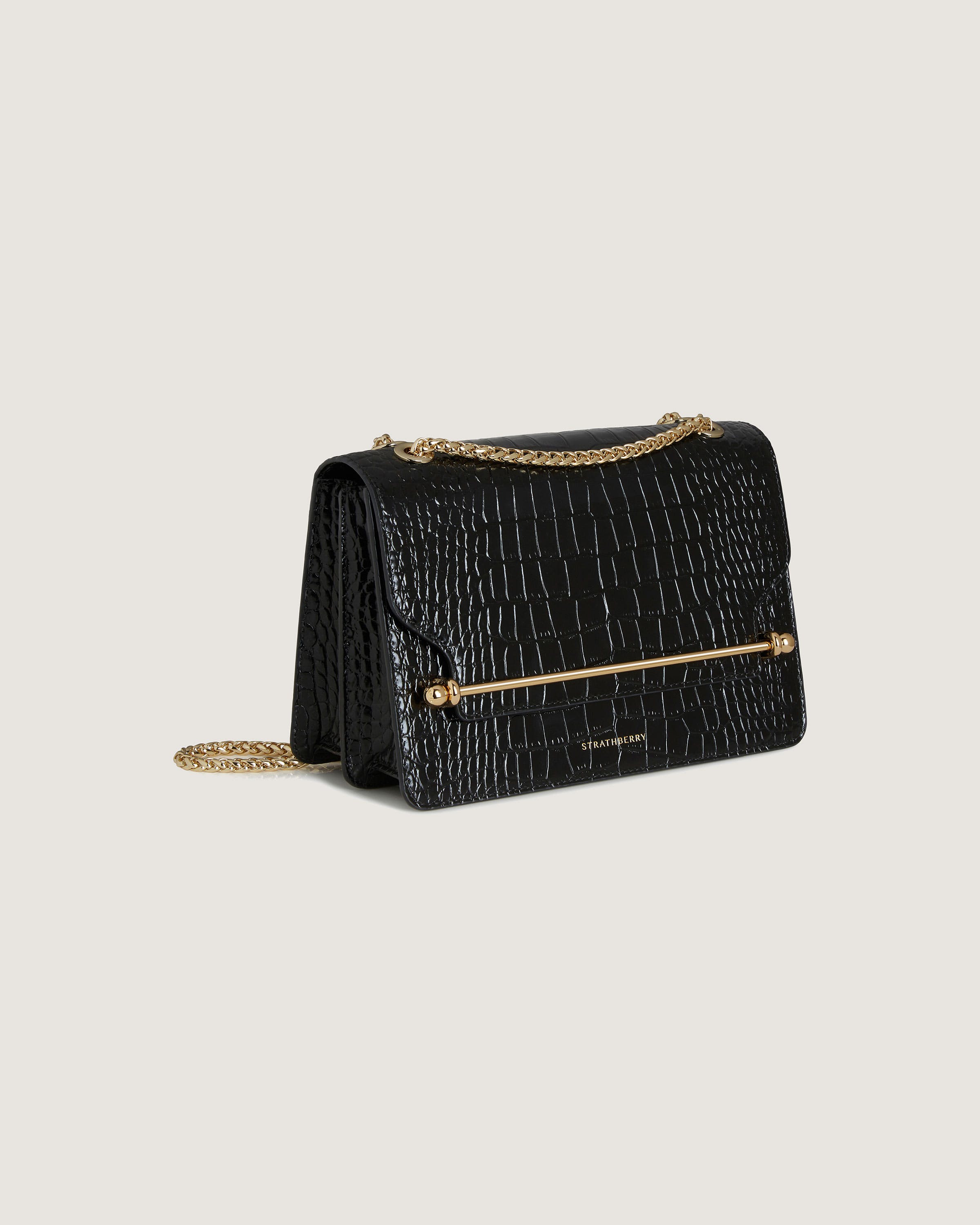 A black purse with a gold chain strap