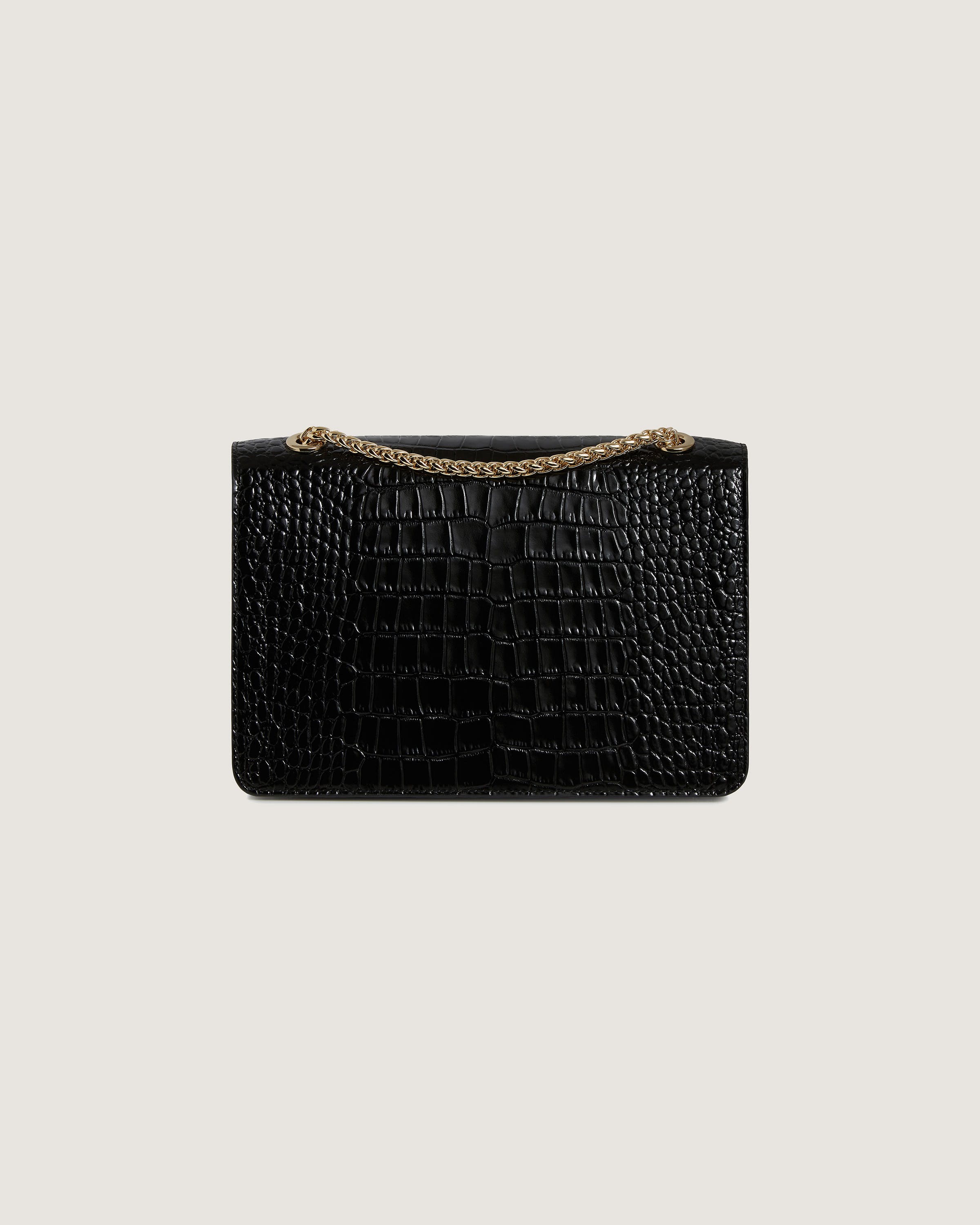 A black crocodile skin purse with a gold chain