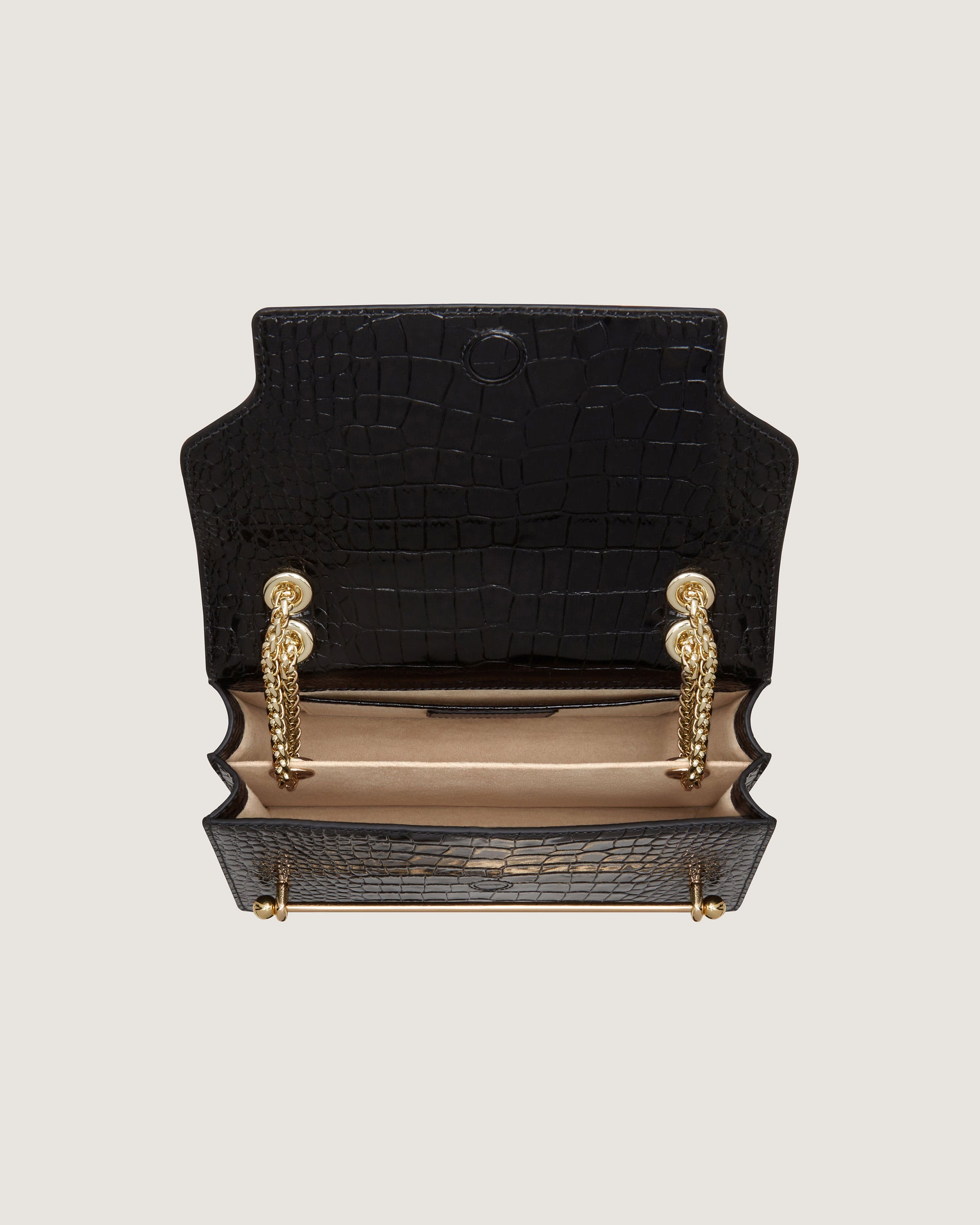 A black purse with a gold handle