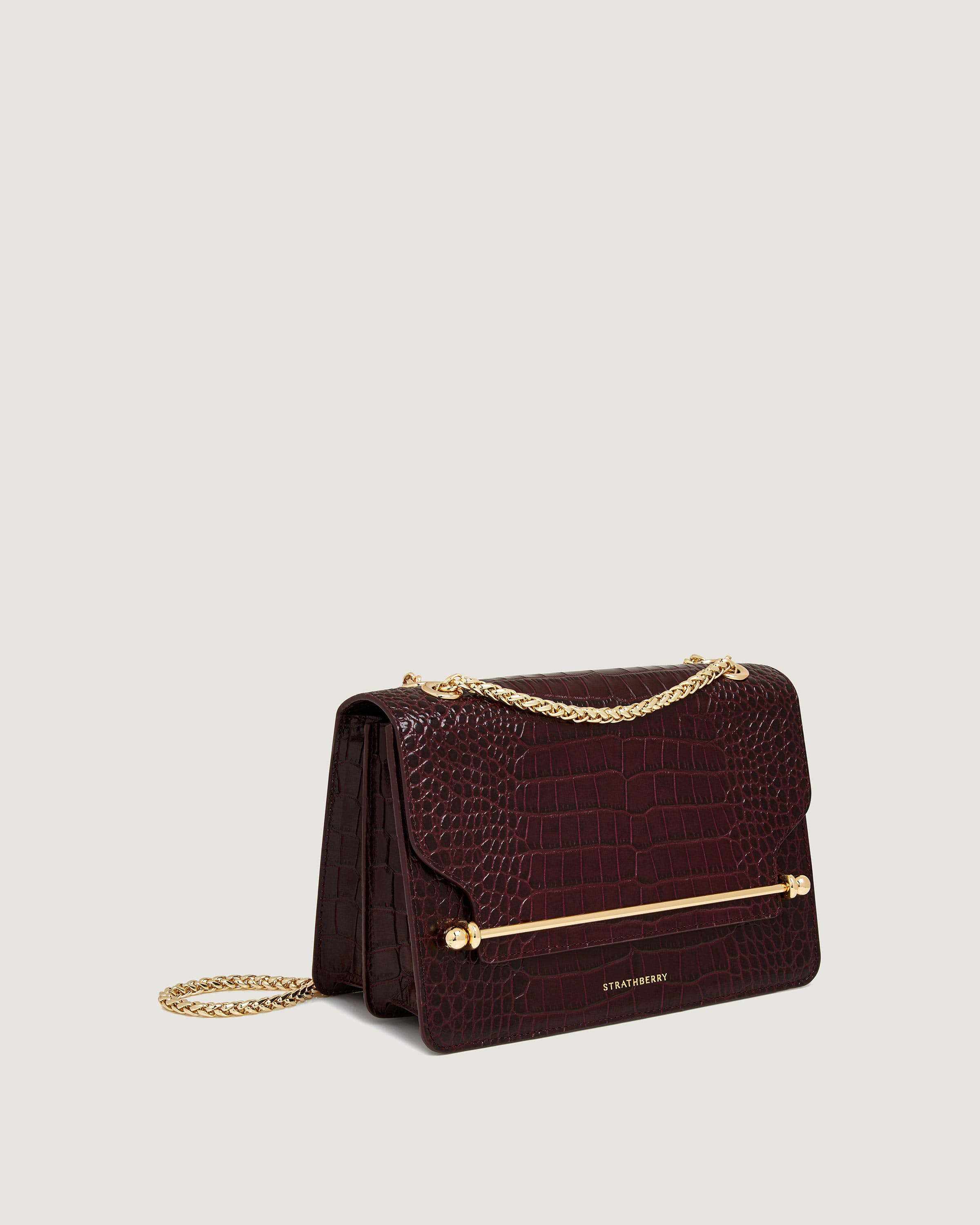 A brown handbag with a gold chain