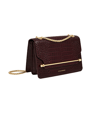 A brown crocodile - embossed purse with a chain strap