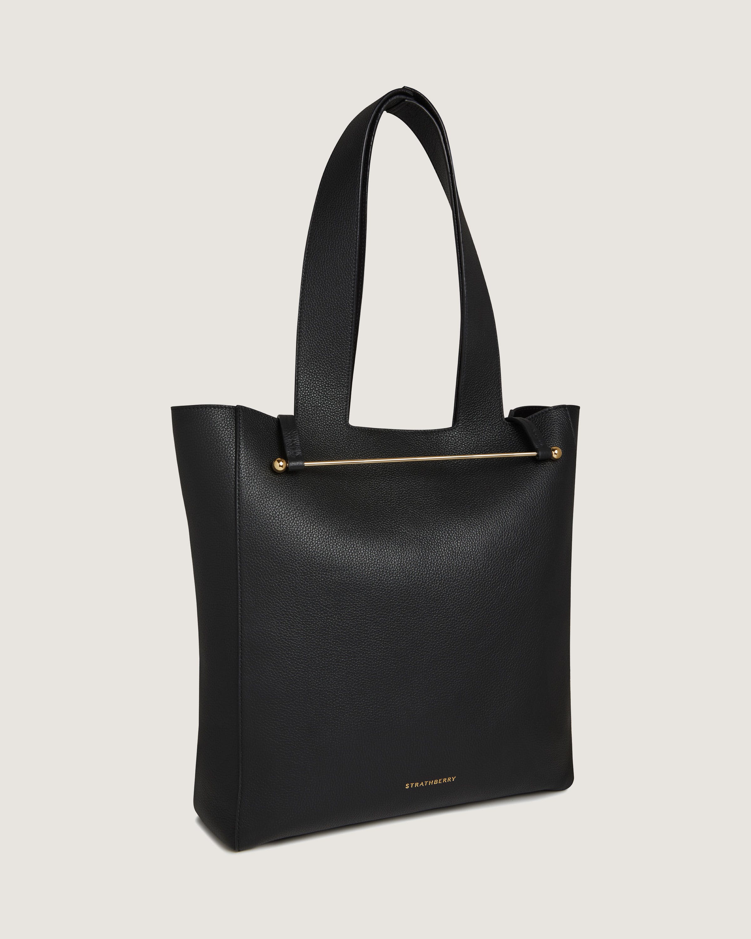 A black tote bag with a gold zipper