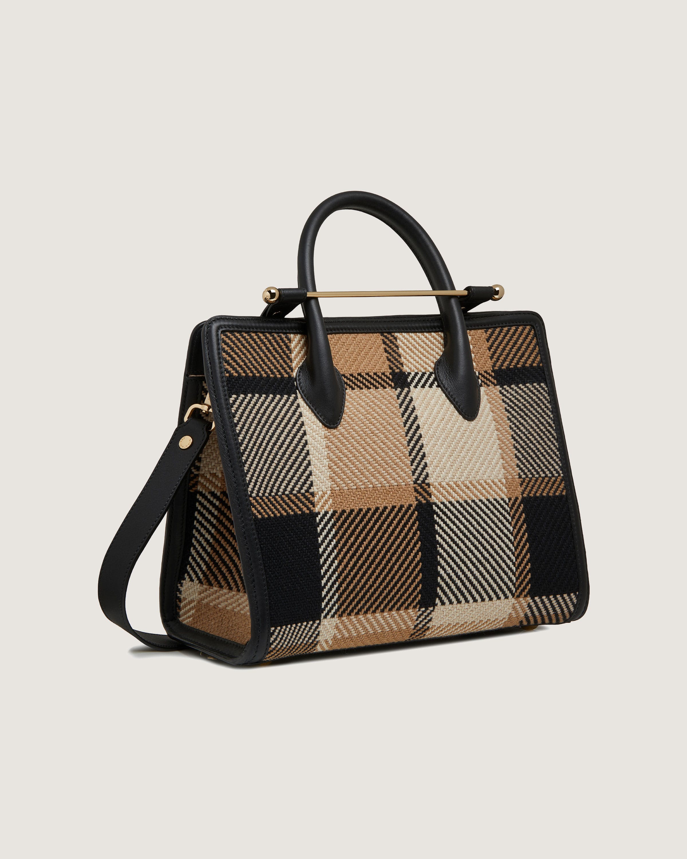 A brown and black plaid handbag on a white background