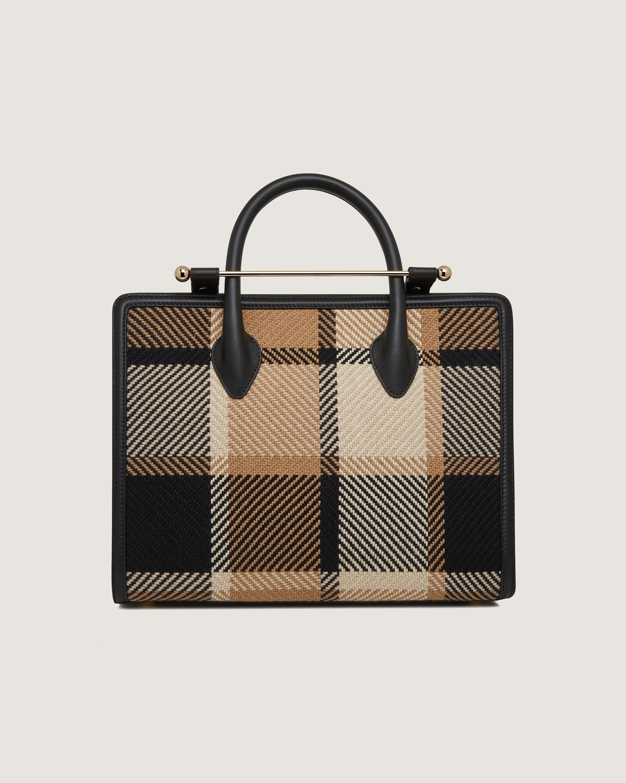 A black and tan plaid bag with a handle