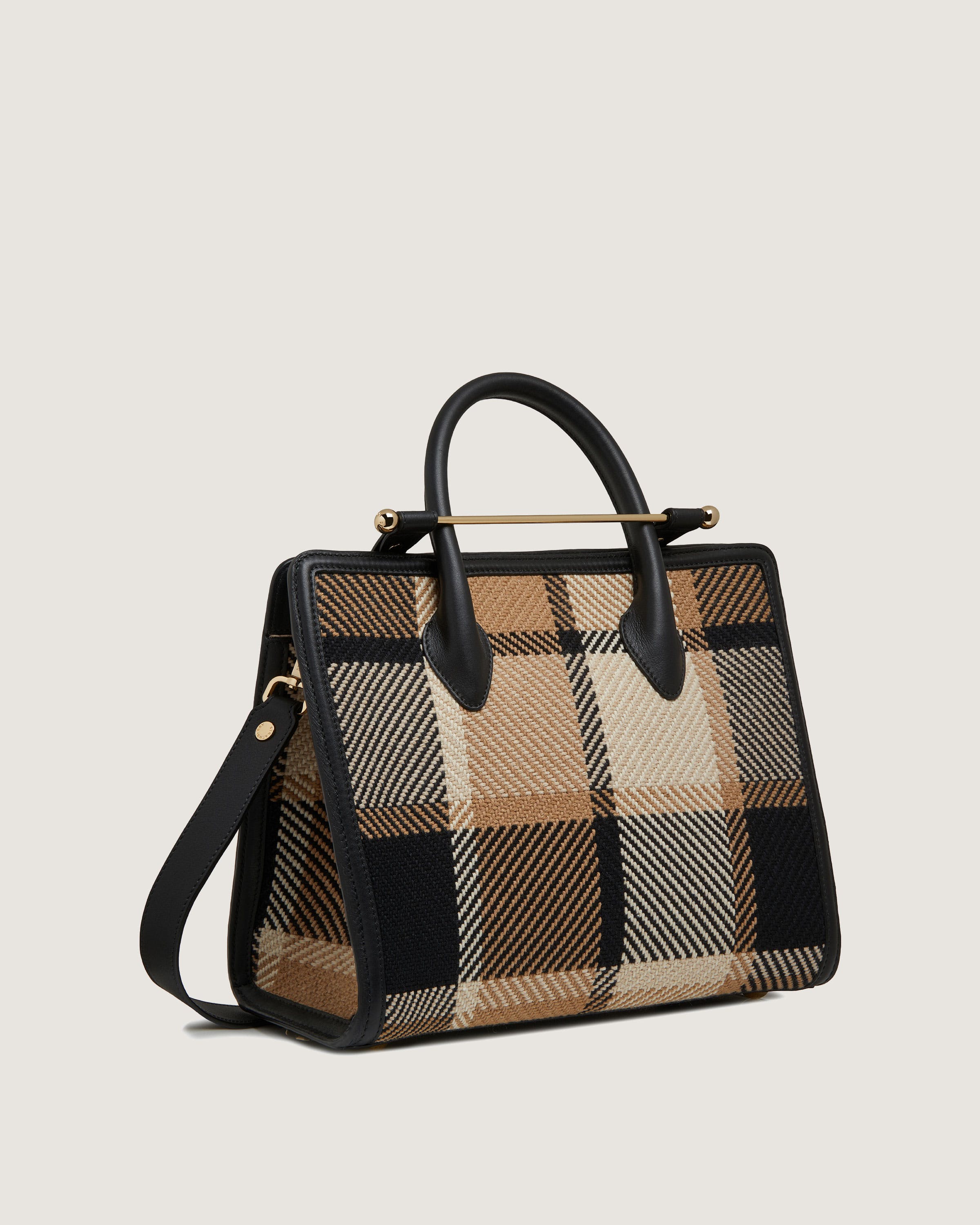 A brown and black plaid handbag on a white background