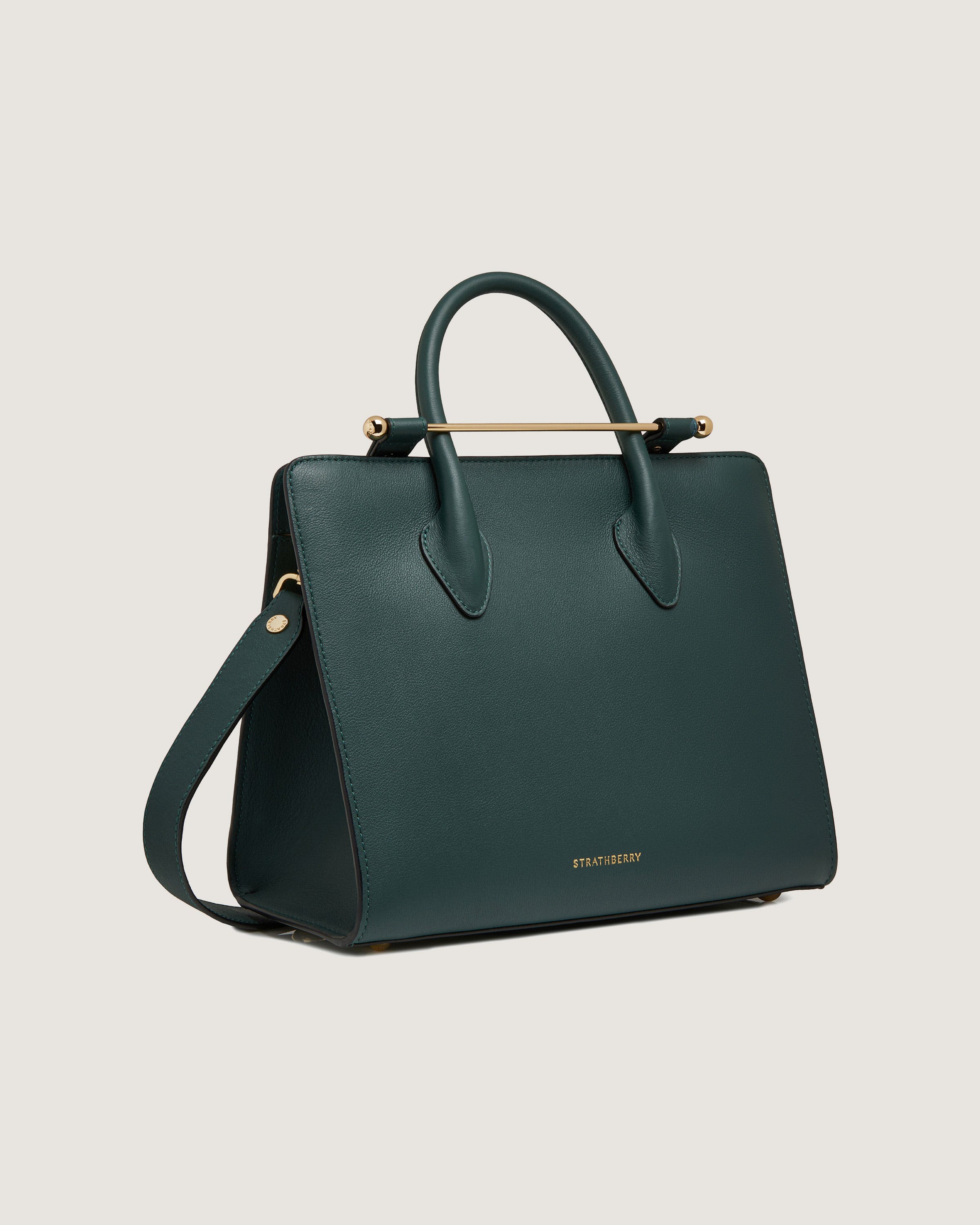 A green handbag with a gold handle